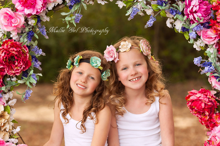 Beautiful headshots of little girls on a flower swing