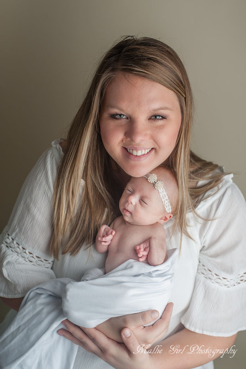 mother smiling with newborn girl