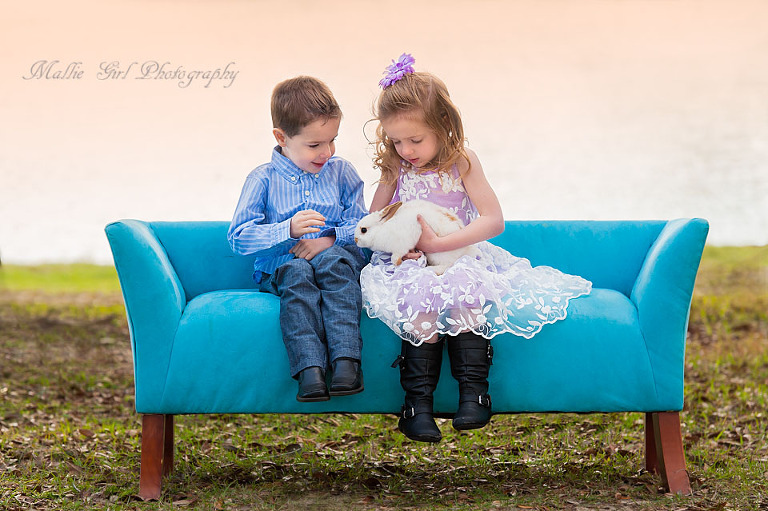 Sweet siblings on couch hold Easter bunny